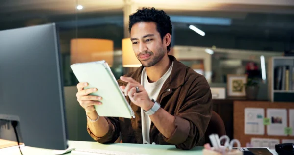 Employer sat at desk reading terms of employee contract.