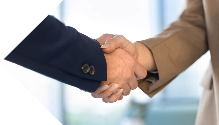 A handshake between a business professional and an HR consultant, representing a successful outsourcing partnership.