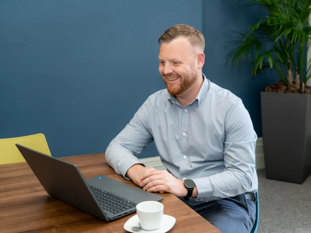 Michael Dobson smiling at laptop during a teams call.